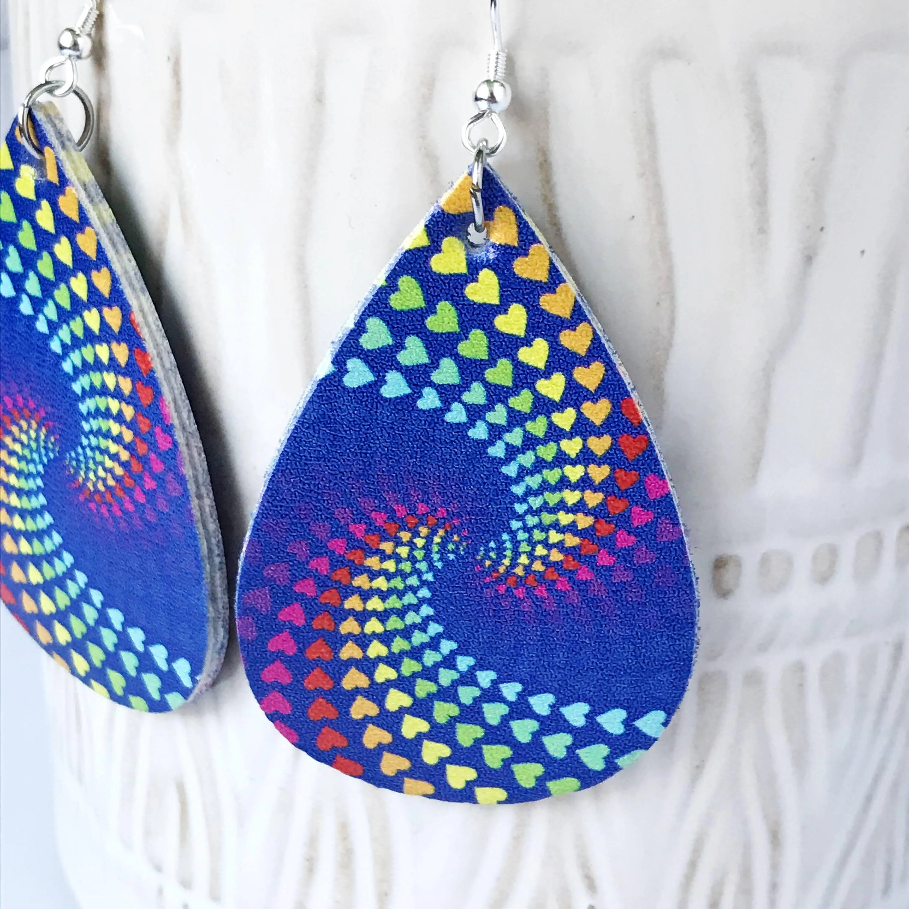 Christin: Rainbow Hearts Swirl on Navy Earrings Faux Leather