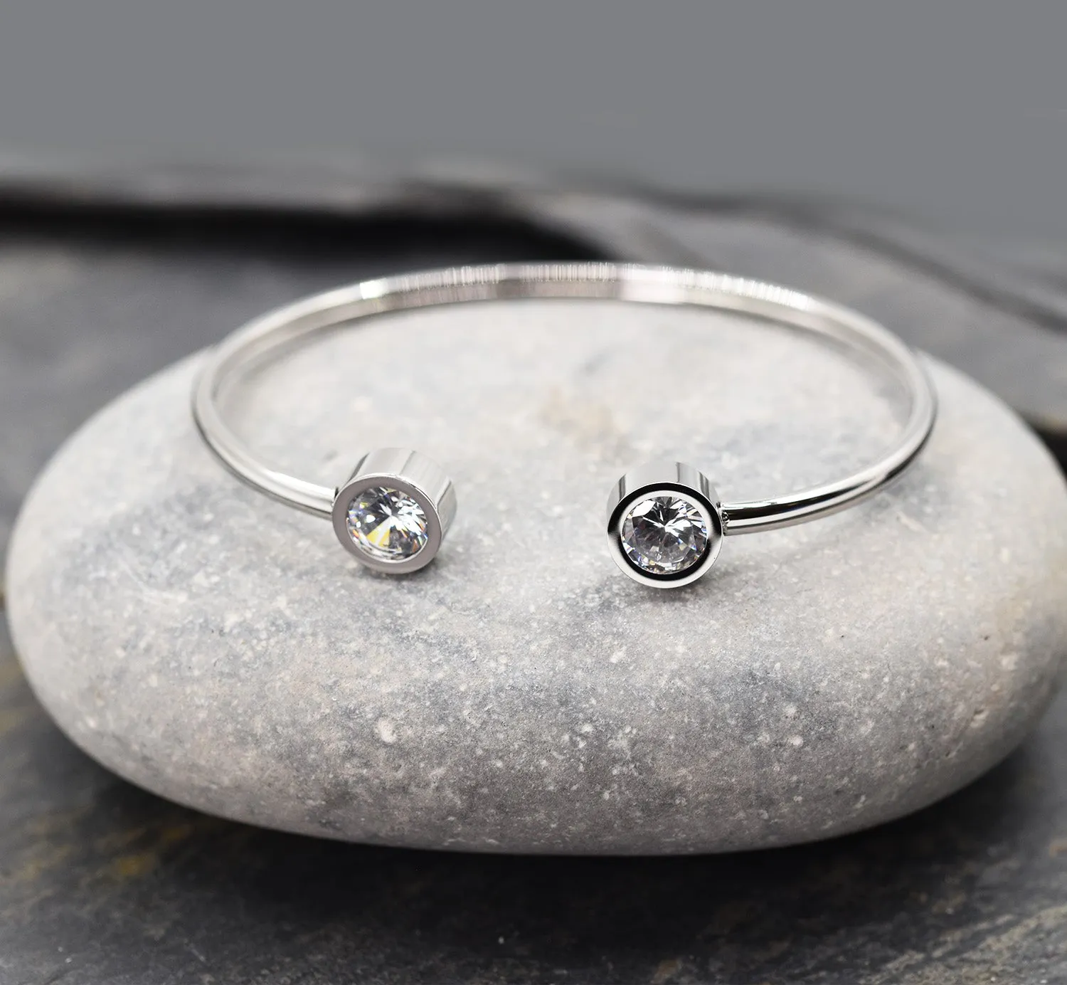 Sleek stainless steel memory style bangle with crystal ends